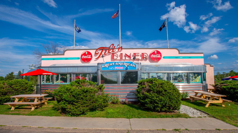 tilt'n diner exterior entrance path and picnic tables