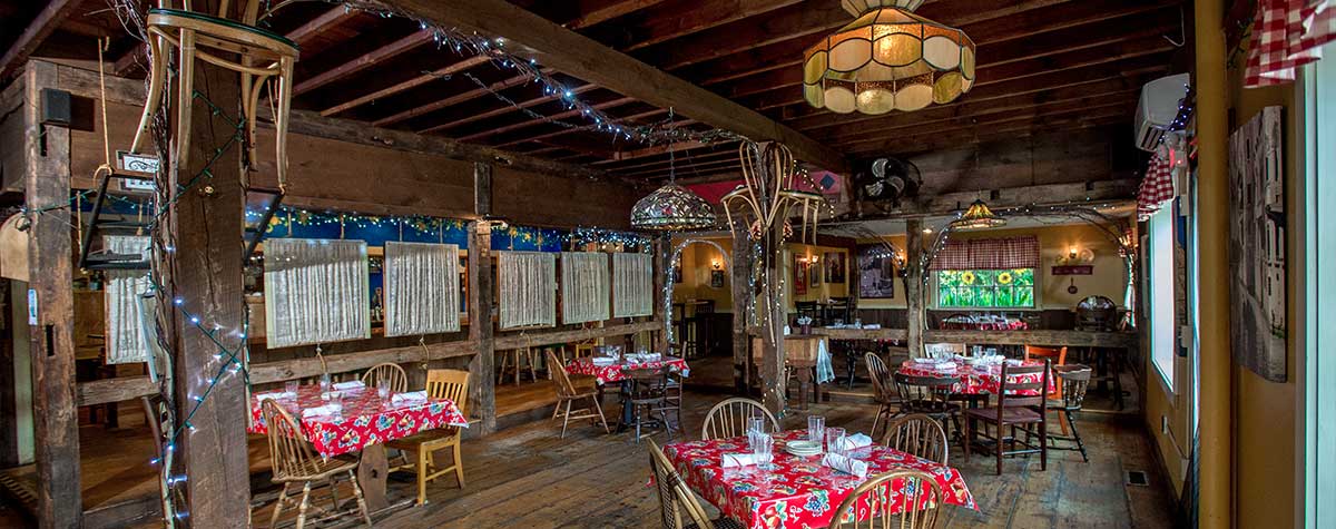 tables set up and around rustic italian farmhouse dining room