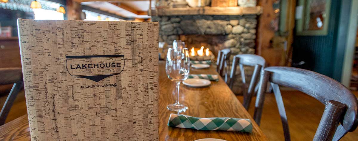 lakehouse menu on table with stone fireplace in background