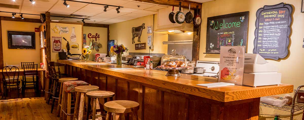 breakfast counter with pastries, and menu chalkboard on wall