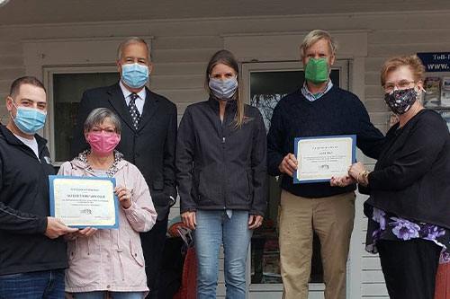 group of people presenting award from meredith area chamber