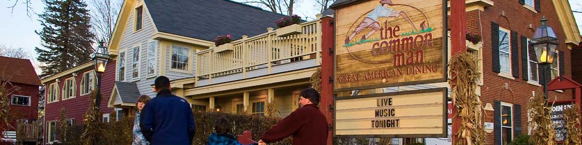 autumn image of common man ashland exterior with family walking up to entrance