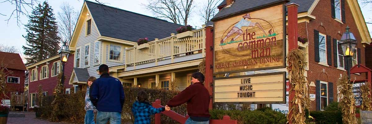 autumn image of common man ashland exterior with family walking up to entrance