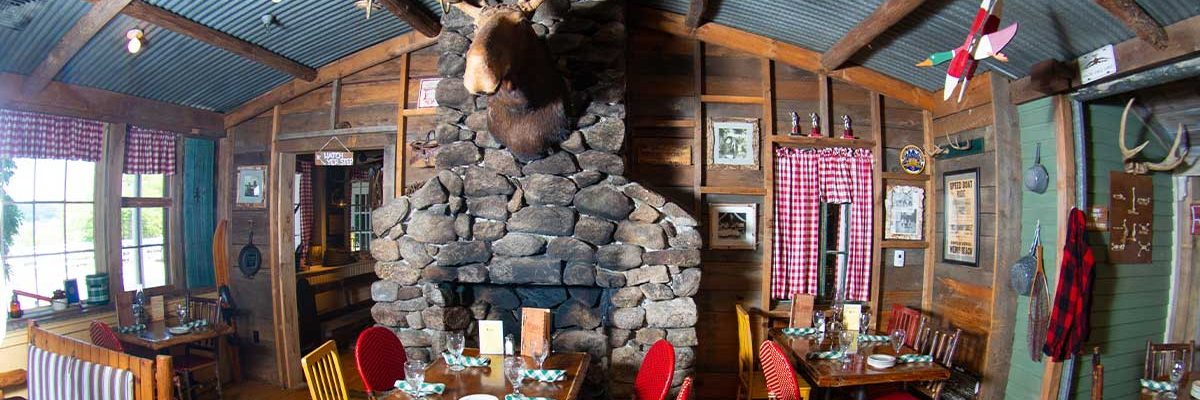 moose head over fireplace in camp dining room