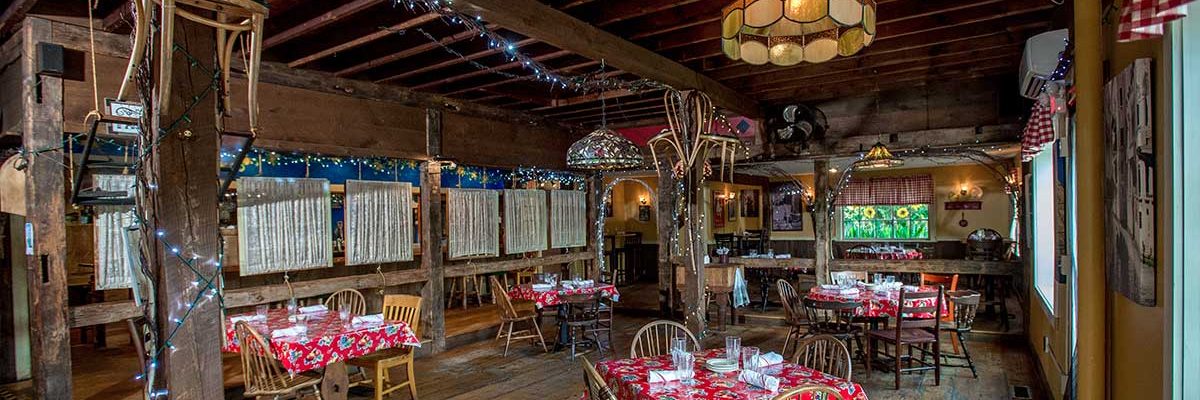 tables set up and around rustic italian farmhouse dining room