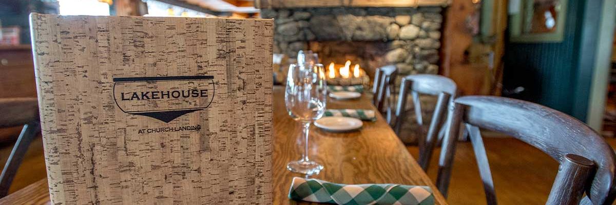 lakehouse menu on table with stone fireplace in background