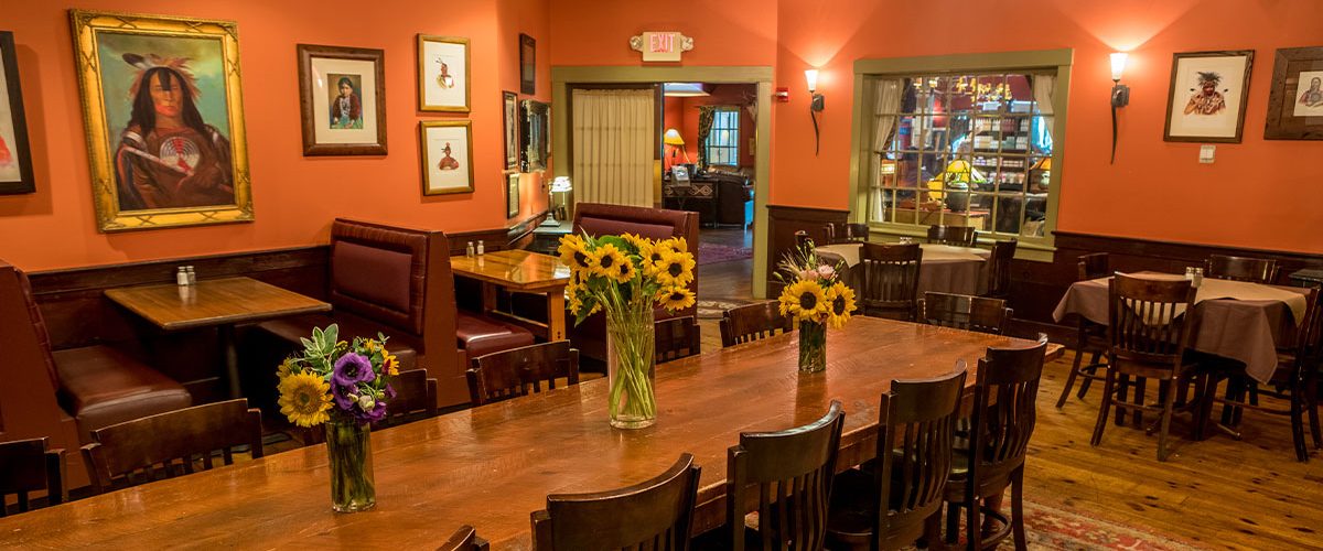 common man inn and spa dining room with sunflowers on tables in vases