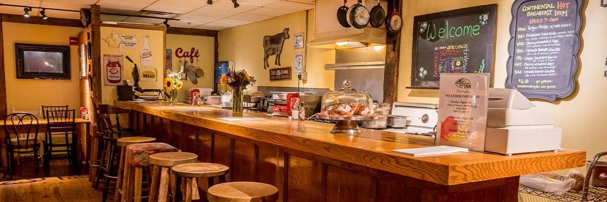 breakfast counter with pastries, and menu chalkboard on wall