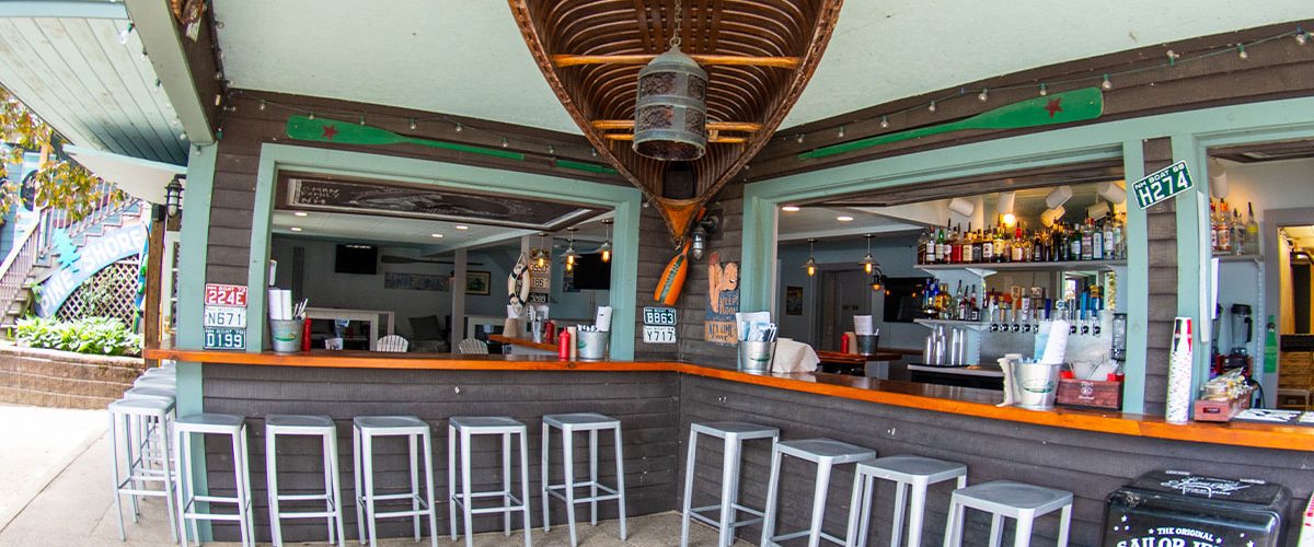 south docks outdoor bar with canoe hanging from ceiling